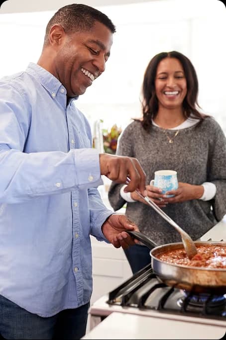 man and woman talking while serving food